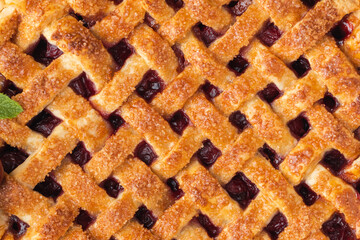 Delicious homemade cherry pie with Flaky Crust as a textured background. American traditional pastry. Flat lay. Fresh summer berry tart dessert sprinkled with sugar