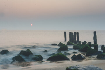 Wall Mural - Sunrise over rocky beach in Delaware.