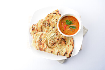 indian baked roti prata canai 2 pieces with spicy chilli curry chicken gravy soup sauce in plate on white background asian halal food cuisine menu for cafe design