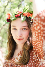 A Woman With A Flower Crown Grabbing A Tree Branch