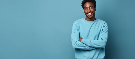 Poster - Dark skinned American man friendly in blue sweatshirt studio background with copy space