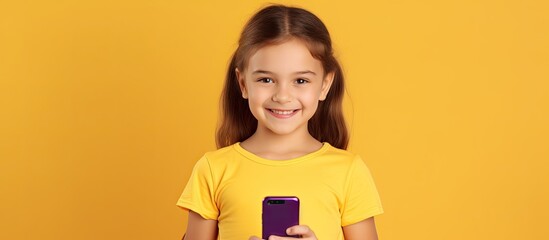 Aufkleber - Caucasian girl in violet T shirt on yellow background holds empty mobile phone
