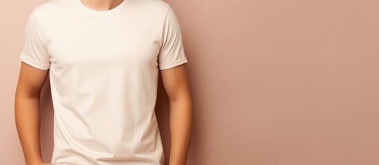 Poster - Male model wearing white t shirt and jeans posing in studio on beige background modern fashion empty area