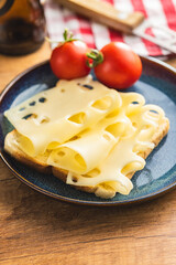 Wall Mural - Slices of cheese on bread  on plate. Tasty sandwich.