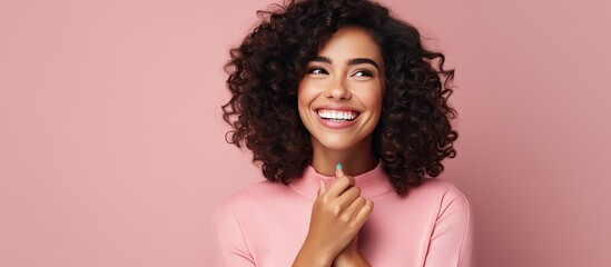 Smiling happy woman indicates idea with hand in open space