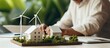 © HN Works - Ecological engineer at home creating windmill models and using laptop for sustainable development Banner Copy space