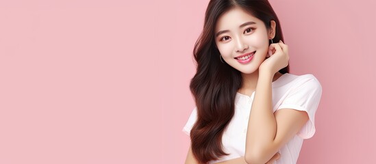 Poster - Asian woman pointing up with smiley face advertising product on pink background