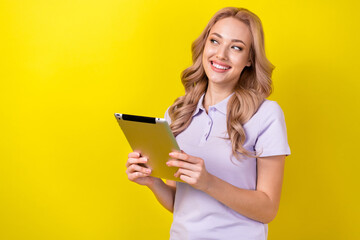 Poster - Photo of adorable thoughtful lady wear purple polo looking empty space typing modern gadget isolated yellow color background