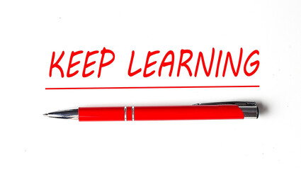 Text KEEP LEARNING with ped pen on the white background
