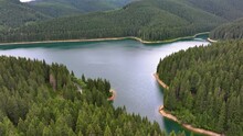 Aerial View Of Blue Lake And Green Forests. Mountain Forest Lake With Pine Trees. View On The Lake Between Mountain Forest. Over Crystal Clear Mountain Lake Water. Fresh Water. Mountain Road