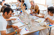 © Alfonso Soler - Art and Wine Workshop. Group of friends painting and drinking wine.
