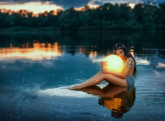 fantasy woman stroking holding moon magic light glowing planet in hands hugs. girl night elf beauty 