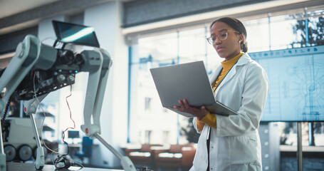 Poster - Young Black Female Engineer Testing Industrial Programmable Robot Animal in a Factory Development Workshop. Professional Researcher in a Lab Coat Developing AI Canine Prototype, Using Laptop