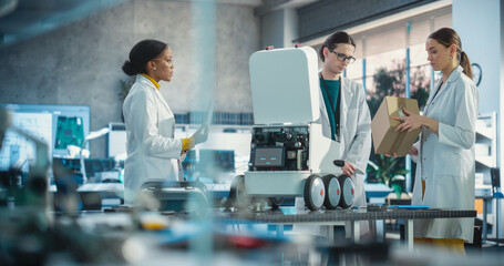 Poster - Team of Industrial Specialists Working on Mobile Robot, Using a Laptop. Young Male and Female Engineers in a Lab Discussing an Automated AI Robotic Delivery Assistant, Brainstorming Improvement Ideas