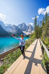 Wall Mural - Woman taking a selfie, Moraine Lake during summer in .Banff National Park, Canadian Rockies, Alberta, Canada...Banff National Park, Alberta, Canada