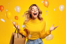 Portrait Of Wow Excited Amazed Woman With Open Mouth Holding Paper Shopping Bag With Colored Helium Balloons On A Yellow Background
