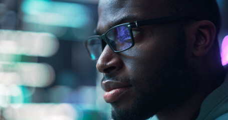 Leinwandbilder - Close Up Portrait of Black Man Working on Computer, Lines of Code Language Reflecting on his Glasses. Male Programmer Developing New Software, Coding, Managing Cybersecurity Project