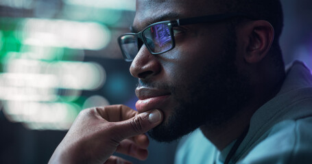 Leinwandbilder - Close Up Portrait of Male Programmer Developing New Software, Coding, Managing Cybersecurity Project. Black Man Working on Computer, Lines of Code Language Reflecting on his Glasses
