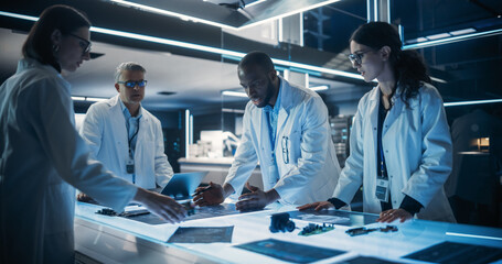 Leinwandbilder - Diverse Team of Industrial Robotics Specialists Working on Innovative Prosthetic Hands in a Research Facility. Young Engineers Discussing the Prototype, Testing Electronic Components