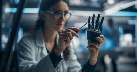 Aufkleber - Portrait of Young Female Scientist Working in Technological Research and Development Company, Assembling an Innovative Bionic Prosthetic Hand. Engineer Working on Technology for Physically Impaired