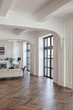 a chic expensive bright interior of a huge living room in a historic mansion with arched arches, columns and white walls decorated with ornaments and stucco.