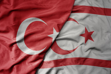 Wall Mural - big waving national colorful flag of turkey and national flag of northern cyprus .