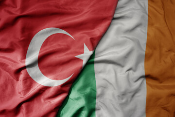 Wall Mural - big waving national colorful flag of turkey and national flag of ireland .
