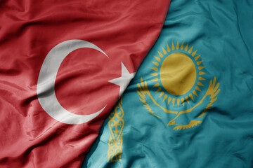 big waving national colorful flag of turkey and national flag of kazakhstan .