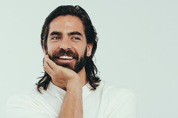 Wall Mural - Masculine beauty: Handsome young man smiling in a studio