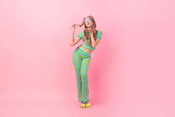 Canvas Print - Full body photo of pretty young girl sending air kiss hand touch hair dressed stylish green print outfit isolated on pink color background