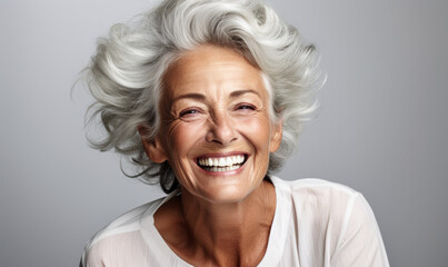 elderly elegance: grey-haired senior model laughing with clean teeth