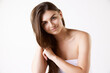 © master1305 - Portrait of beautiful brunette young woman with long straight hair, standing in towel against white studio background. Concept of female beauty, hair care, cosmetology and cosmetics, health, ad