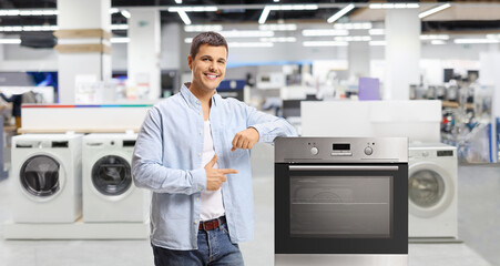 Canvas Print - Guy pointing at an oven in a store