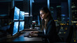 © Studio Nova - Young woman works in an office at night at her computer