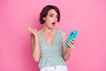 Sticker - Portrait of crazy young lady cyan top holding smartphone modern device shock oops miss clicked website isolated on pink color background