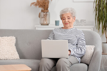 Sticker - Senior woman using laptop at home