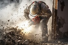 A Laborer Uses A Jackhammer To Break Up A Concrete.