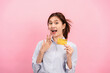 © Katcha - Young asian woman holding credit card and raising one hand to covering mouth while feeling surprised