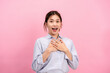 © Katcha - Young asian woman use both hands touching on the chest and open mouth while feeling shocked and scared