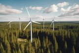 Fototapeta Big Ben - A close-up aerial shot of windmills surrounded by green forest in Finland generating renewable energy. Generative AI