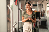 Passenger Woman Standing in Tram, Listening Music Online On Phone