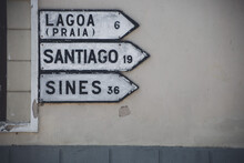 Road Signs In Melides, Alentejo, Directing The Way To Lagoa, Santiago, And Sines. Quintessential Alentejo Charm.