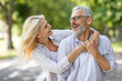Happy active senior couple having fun together outdoors
