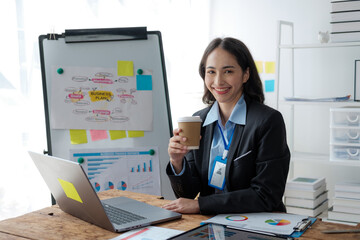 Aufkleber - Asian Businesswoman Using laptop computer and working at office with calculator document on desk