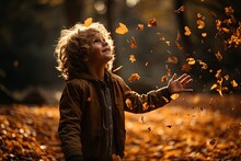Little Boy Having Fun During Stroll In The Forest At Sunny Autumn Day. Child Playing Maple Leaves. Baby Tossing The Leaves Up. Active Family Time On Nature. Hiking With Little Kids. Dry Leaves Rustle.