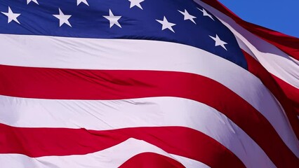 Wall Mural - close up of the us flag blowing in the breeze.