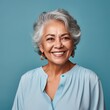 Portrait of a Mature Latino Woman Headshot on a Blue Background