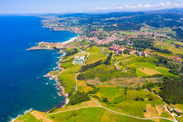Wall Mural - Scenic view from drone of coastal Spanish township of Comillas on sunny summer day, Cantabria