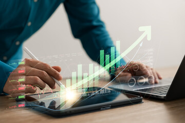 Wall Mural - Businessman analyzing company's financial balance sheet working with digital augmented reality graphics. Businessman calculates financial data for long-term investment.