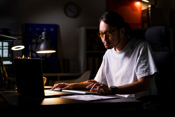 Aufkleber - Asian man graphic designer working on computer drawing sketches logo design. The concept of a new brand. Professional creative occupation with idea.